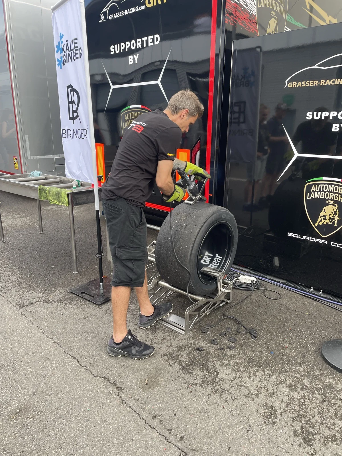 Mecânico da GRT com um pneu traseiro de Lamborghini